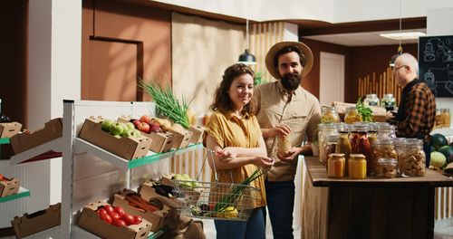 Portrait of smiling friends with food at home