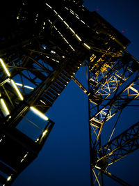 Low angle view of illuminated bridge against sky at night