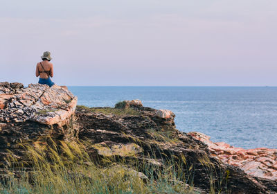 Women looking at sea against sky