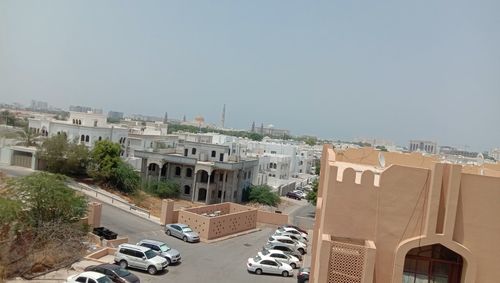 Buildings in city against clear sky