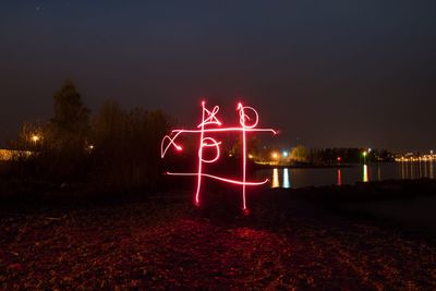 Illuminated light painting on building at night