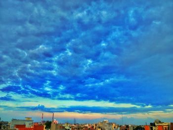 Buildings against cloudy sky