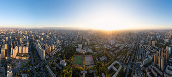 Aerial view of cityscape against sky during sunset