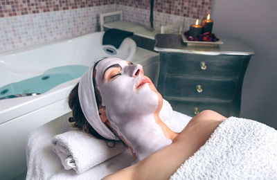 Midsection of man lying down in bathroom