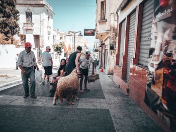 People walking on street in city