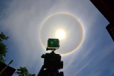 Low angle view of illuminated street light against sky