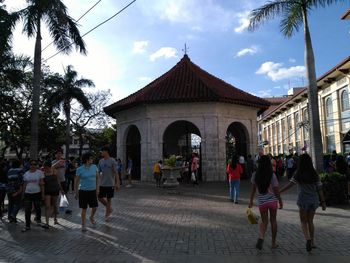 People walking in front of building