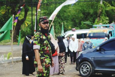 Portrait of men with army equipment standing on street