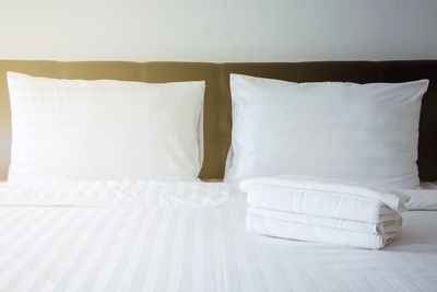 Stack of towels on bed