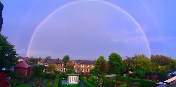 Scenic view of rainbow over buildings in city