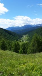 Scenic view of mountains against cloudy sky