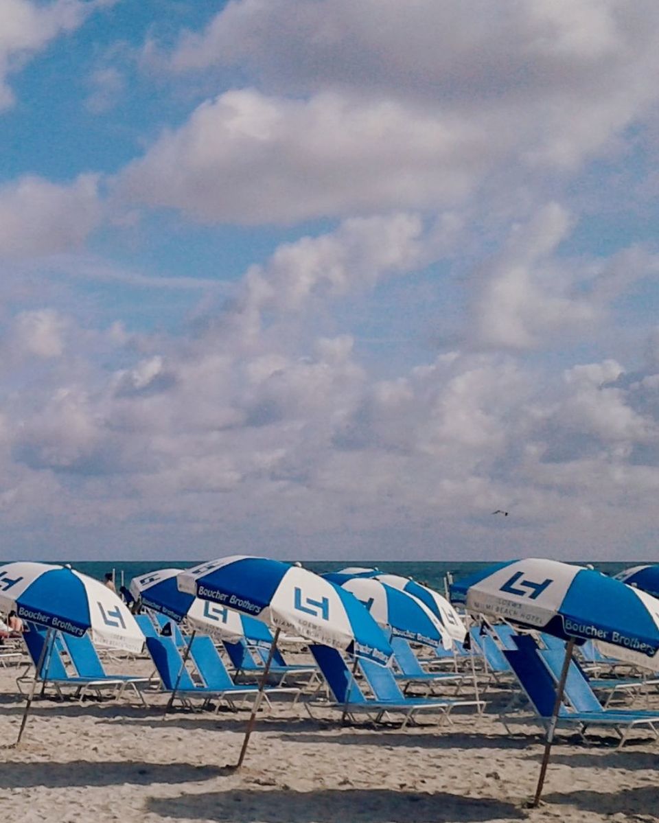 beach, sand, sky, cloud - sky, sun lounger, in a row, outdoors, shore, canopy, day, sea, nature, no people, group of objects, blue, arrangement, vacations, summer, shelter, tent, beauty in nature, water, horizon over water