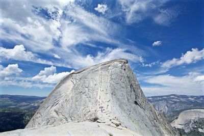 Scenic view of mountains against cloudy sky