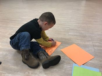 High angle view of boy sitting on floor
