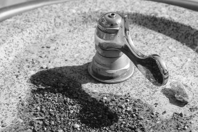 High angle view of faucet on sand