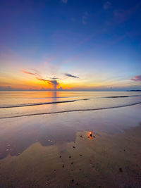 Scenic view of sea against sky at sunset