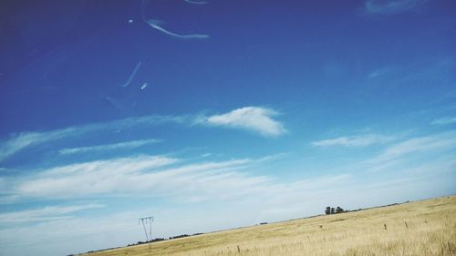 Scenic view of landscape against blue sky