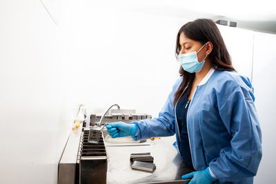 Female doctor examining chemical in laboratory