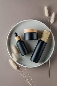 Eco friendly black glass dropper bottle, cream jar and spay toner with bamboo lid. zero waste 