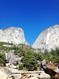 View of mountain range against clear blue sky