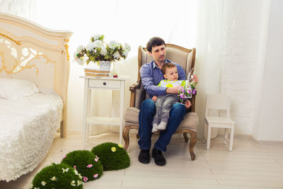 Full length of women sitting on floor