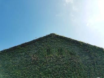 Low angle view of mountain against clear blue sky