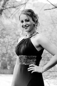 Portrait of smiling young woman standing outdoors