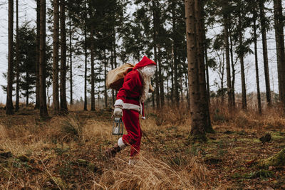 Man wearing santa costume in forest