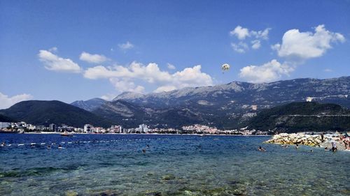 Scenic view of sea and mountains against sky