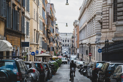 Cars on street amidst buildings in city