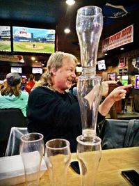 Midsection of man standing in wineglass