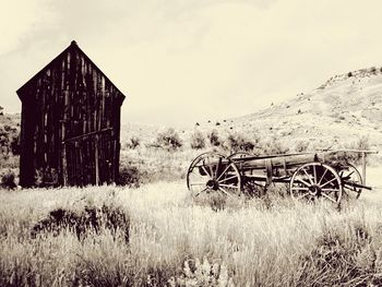 Abandoned barn on field against sky