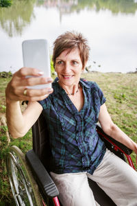 Portrait of smiling woman using mobile phone