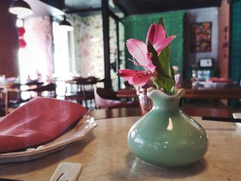 Close-up of pink flower vase on table at home