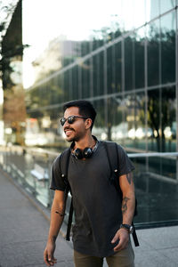 Young man wearing sunglasses standing outdoors