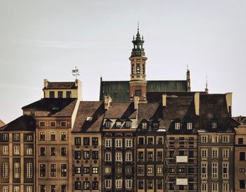 Clock tower in city against sky