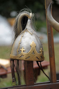 Close-up of wooden post hanging on wood