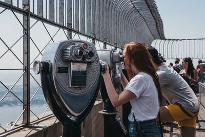 Rear view of woman photographing