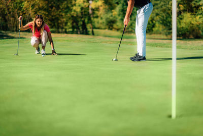 Golf couple putting on the green