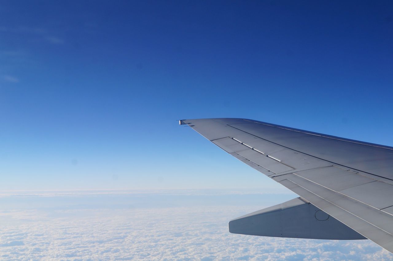 airplane, sky, blue, travel, aircraft wing, transportation, no people, clear sky, air vehicle, day, outdoors, airplane wing, nature, cityscape