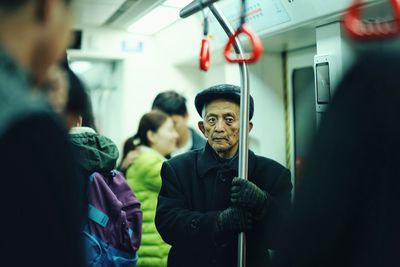 Portrait of mature man standing in train