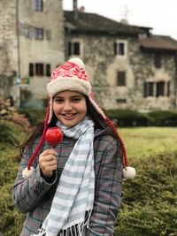 Portrait of smiling young woman standing outdoors