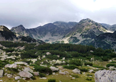 Scenic view of mountains against cloudy sky