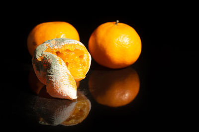 Close-up of orange fruit against black background