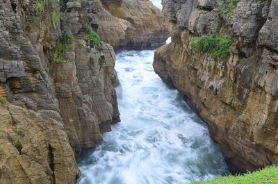 Scenic view of river flowing through rocks