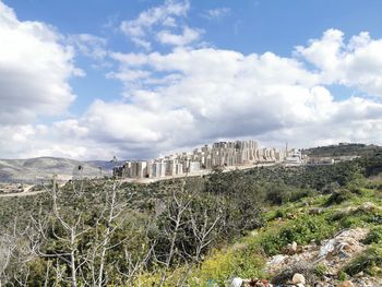 Built structure on landscape against sky