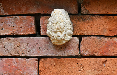 Carved stone on brick wall