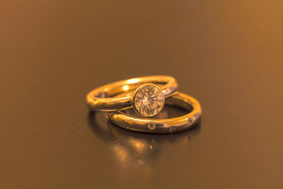 Close-up of wedding rings on table