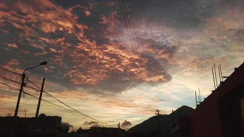 Low angle view of silhouette buildings against sky during sunset