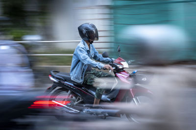 Motion blur of a woman riding a motorcycle